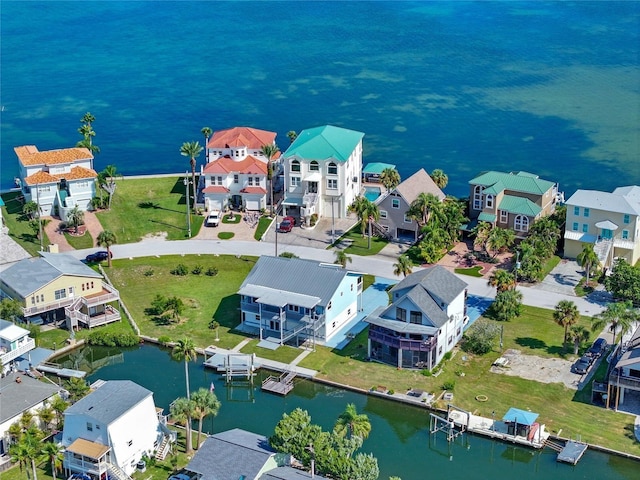 birds eye view of property with a water view and a residential view