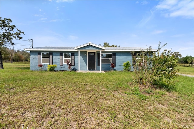 ranch-style home with a front lawn