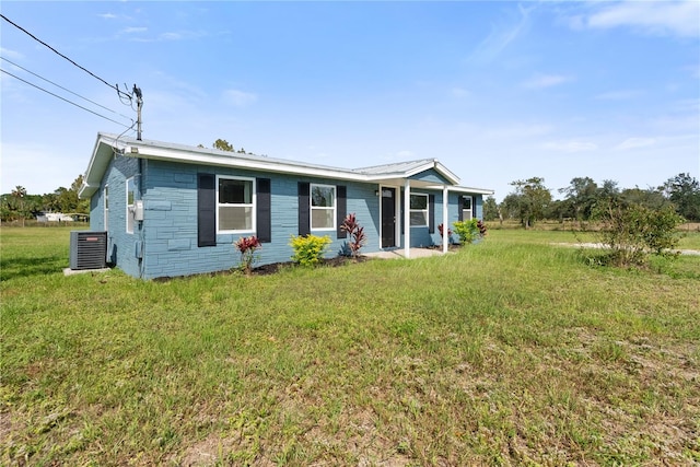 view of front of house featuring a front yard and central air condition unit