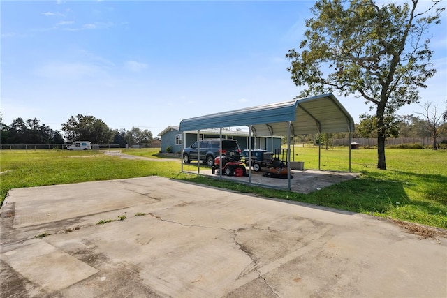 view of vehicle parking featuring a lawn and a carport