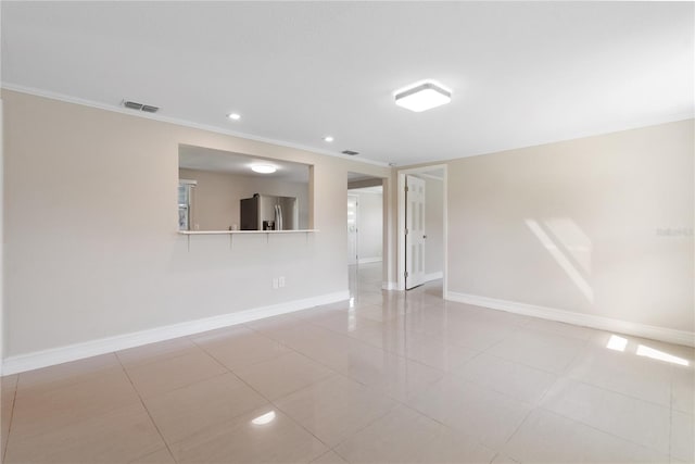 tiled empty room with crown molding