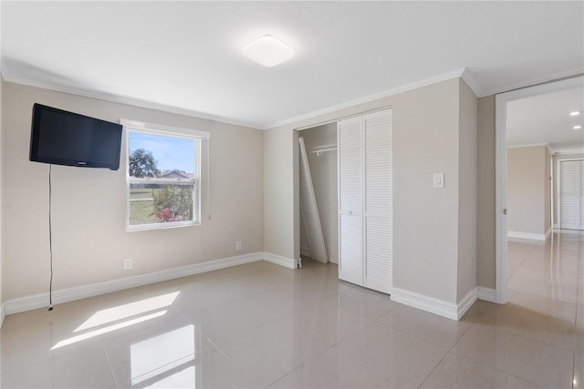 unfurnished bedroom with ornamental molding and tile patterned flooring