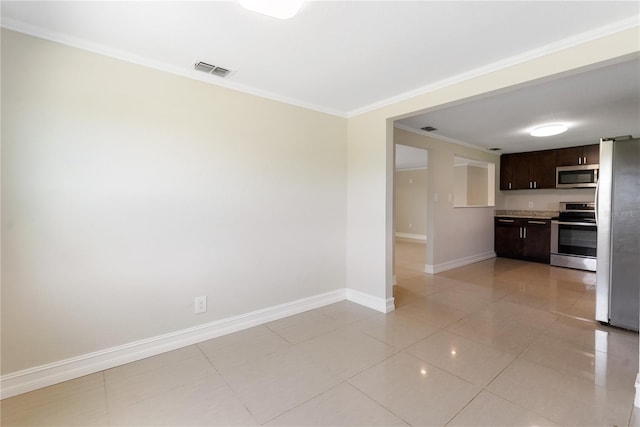 kitchen with stainless steel appliances, dark brown cabinetry, light tile patterned floors, and ornamental molding