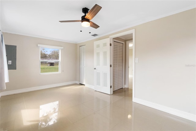 unfurnished bedroom featuring crown molding, electric panel, light tile patterned flooring, and ceiling fan