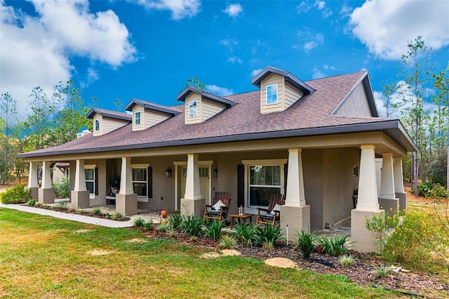 rear view of property with a yard and covered porch