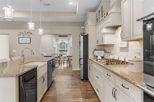 kitchen featuring stainless steel appliances, hanging light fixtures, beverage cooler, and white cabinetry