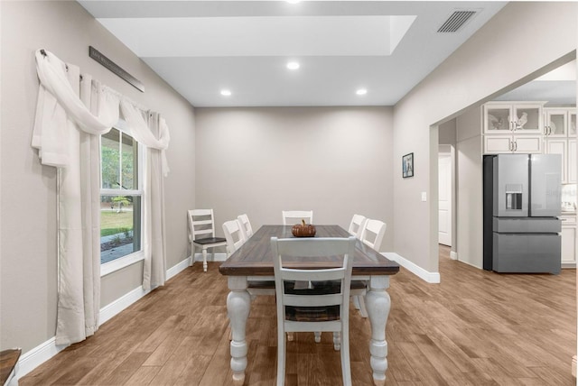 dining space with light hardwood / wood-style floors