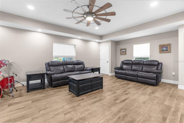 living room featuring ceiling fan and light hardwood / wood-style floors