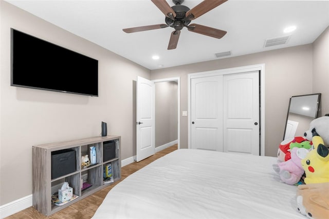 bedroom featuring a closet, hardwood / wood-style flooring, and ceiling fan