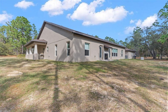 view of side of home with a lawn