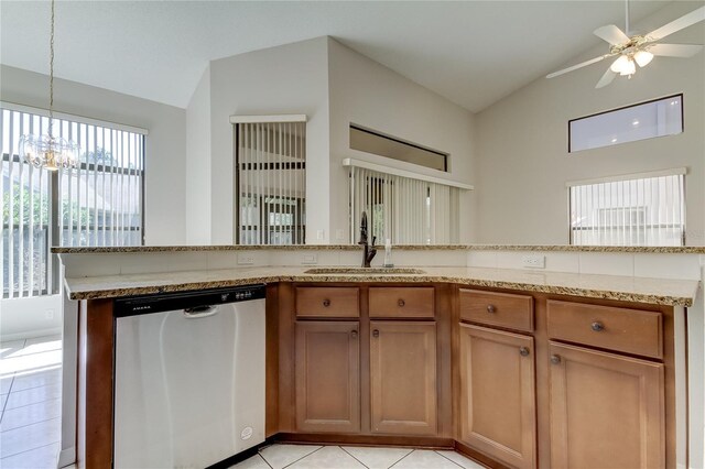 kitchen featuring ceiling fan with notable chandelier, sink, light tile patterned floors, dishwasher, and lofted ceiling