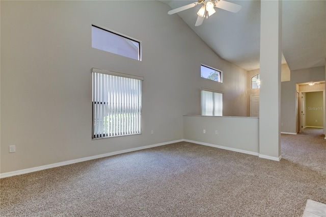 unfurnished room with carpet, a wealth of natural light, high vaulted ceiling, and ceiling fan