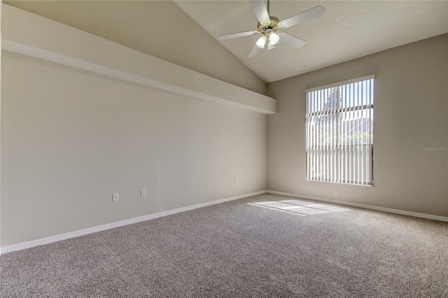 carpeted spare room featuring ceiling fan and lofted ceiling