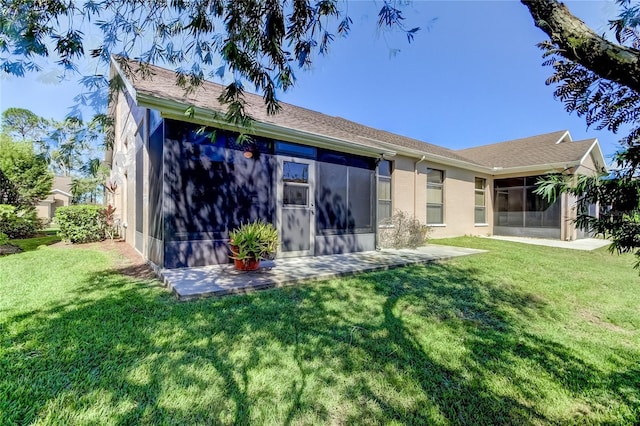 back of property featuring a sunroom and a lawn