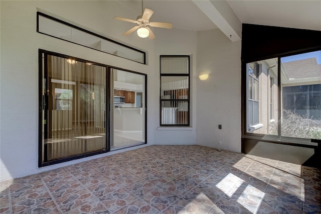 interior space with ceiling fan