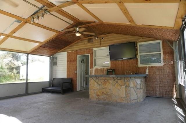 unfurnished sunroom with lofted ceiling and ceiling fan