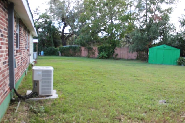 view of yard with a storage unit and central AC