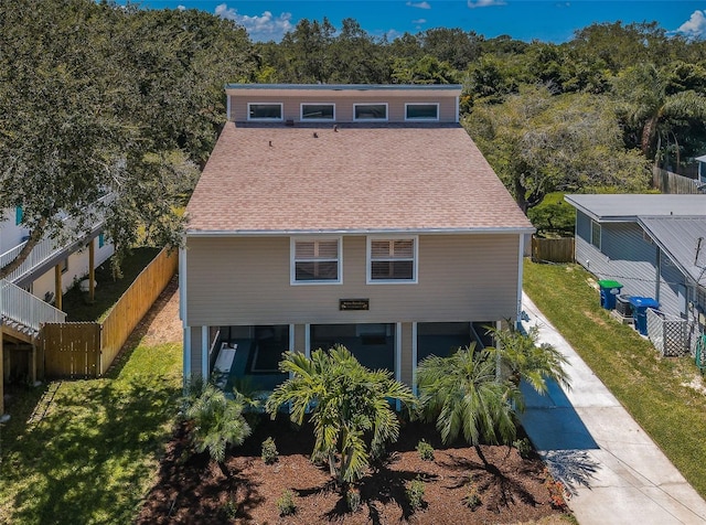 rear view of house with a yard