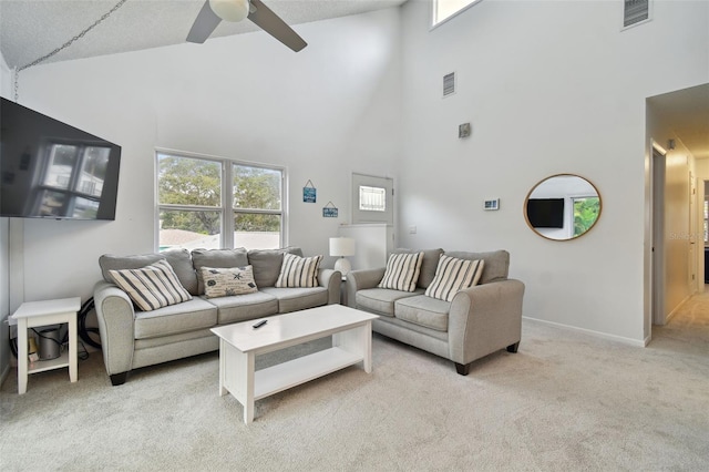 carpeted living room featuring ceiling fan, a textured ceiling, and high vaulted ceiling