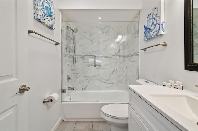 full bathroom featuring vanity, enclosed tub / shower combo, and toilet