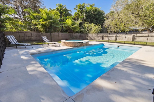 view of swimming pool featuring an in ground hot tub and a patio