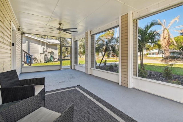 sunroom / solarium featuring ceiling fan