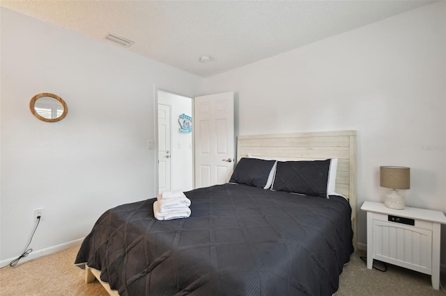 carpeted bedroom with a textured ceiling