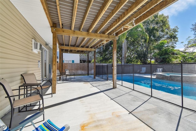 view of patio / terrace featuring a swimming pool with hot tub