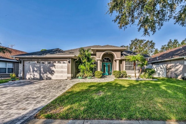 view of front of property with a front yard and a garage