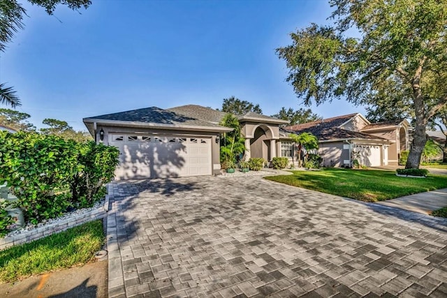 view of front of home featuring a front yard and a garage