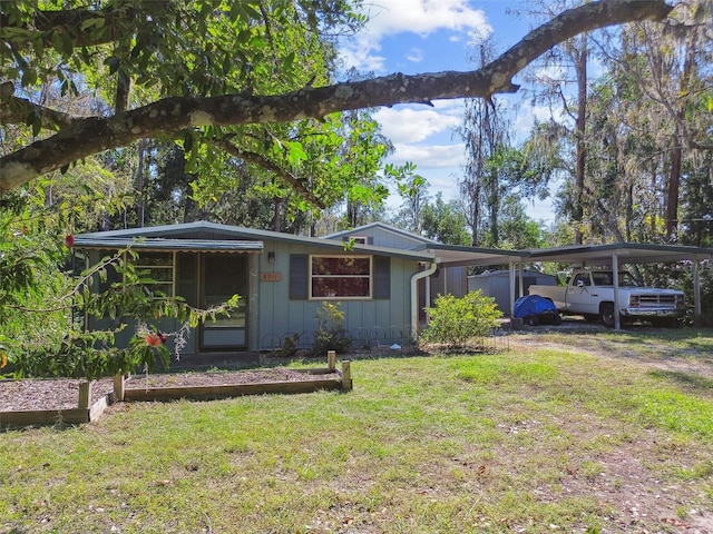 ranch-style home with a front lawn and a carport