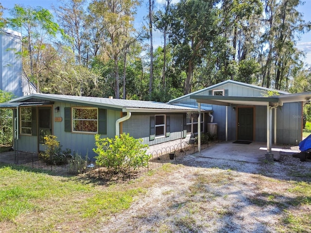 ranch-style home featuring a carport