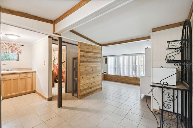 bathroom with tile patterned flooring, wooden walls, vaulted ceiling with beams, and ornamental molding