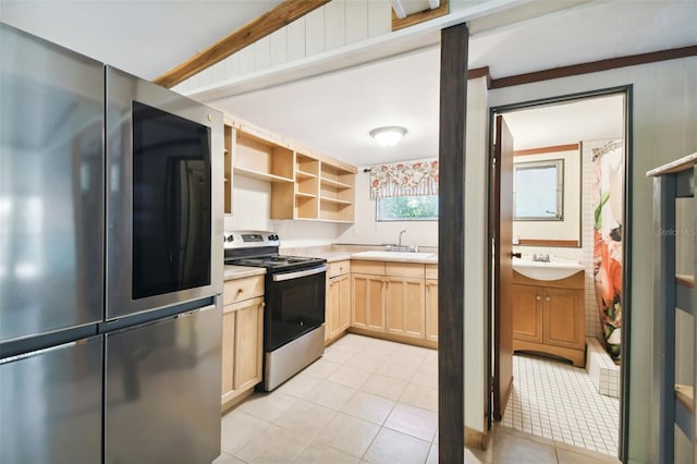 kitchen with light brown cabinetry, sink, light tile patterned floors, and stainless steel appliances