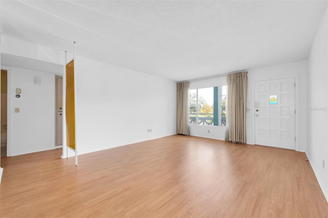 interior space featuring a textured ceiling and light hardwood / wood-style flooring