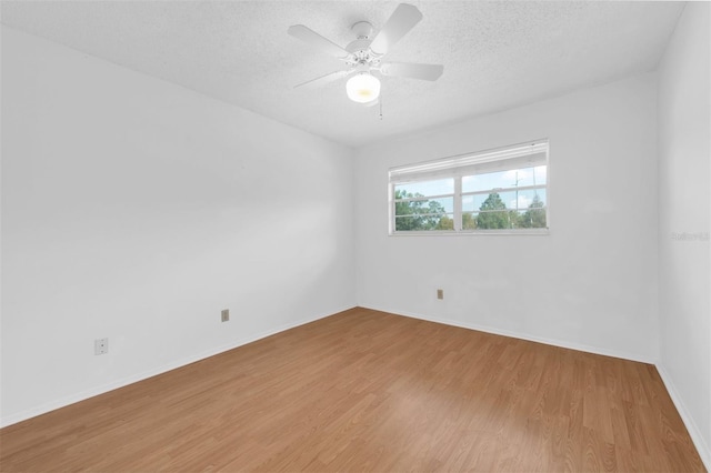 spare room featuring a textured ceiling, hardwood / wood-style flooring, and ceiling fan