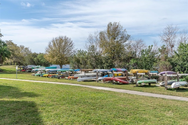 view of parking / parking lot featuring a yard