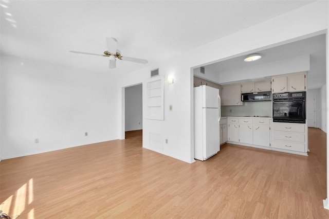 kitchen featuring oven, ceiling fan, light hardwood / wood-style floors, and white refrigerator