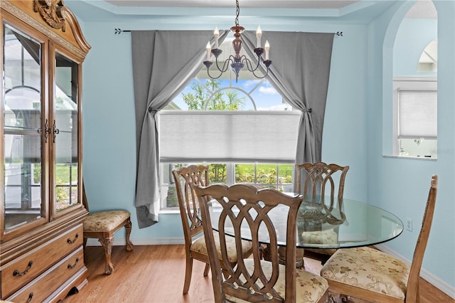 dining area with an inviting chandelier and light wood-type flooring