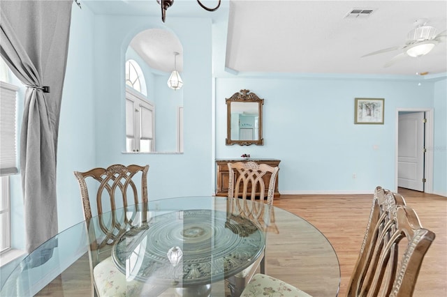 dining space with ceiling fan, crown molding, and hardwood / wood-style floors