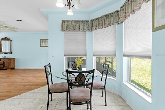 dining room with crown molding, light hardwood / wood-style flooring, and ceiling fan