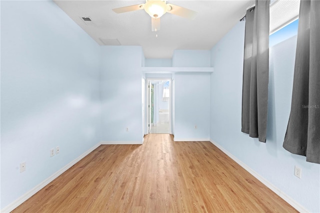 empty room with ceiling fan, light hardwood / wood-style floors, and plenty of natural light