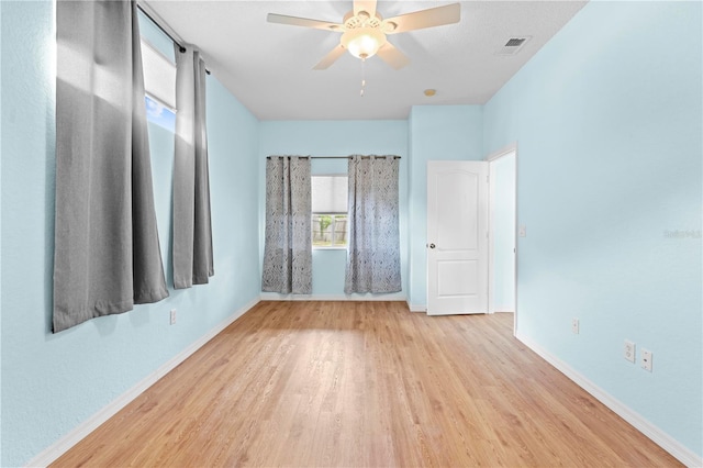 unfurnished room featuring light hardwood / wood-style flooring and ceiling fan