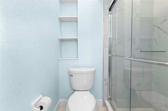 bathroom with toilet and an enclosed shower