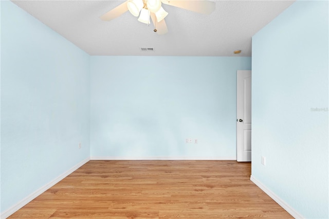 spare room featuring light hardwood / wood-style flooring, a textured ceiling, and ceiling fan