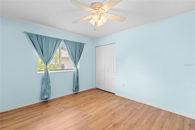 unfurnished room featuring ceiling fan, a textured ceiling, and light hardwood / wood-style flooring