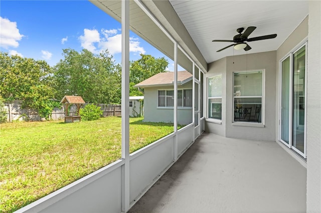 unfurnished sunroom featuring ceiling fan