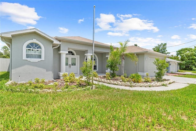 ranch-style home with a front lawn and a garage