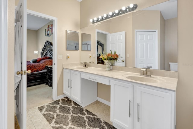 bathroom with tile patterned floors, vanity, and toilet