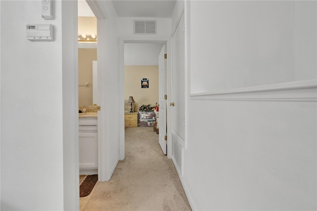 hallway with light colored carpet